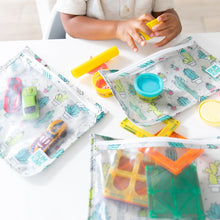Load image into Gallery viewer, A child plays with toys and play dough at a white table with Bumkins Clear Travel Bag 3-Pack: Cacti nearby.