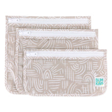 Load image into Gallery viewer, Bumkins Clear Travel Bag 3-Pack: Wander includes three pouches with a white abstract pattern on beige waterproof fabric and white zippers.
