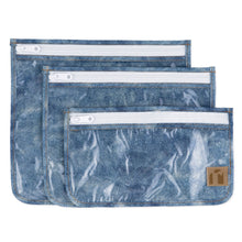 Load image into Gallery viewer, Roamio by Bumkins Clear Travel Bag 3 Pack: Crushed Denim—3 TSA-compliant waterproof pouches made of blue denim printed waterproof fabric.