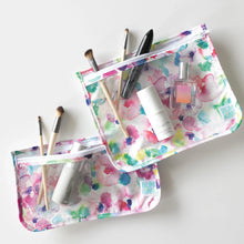 Load image into Gallery viewer, Two Bumkins Clear Travel Bag 3-Pack: Watercolor hold cosmetic items on a white background.