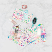 Load image into Gallery viewer, Bumkins Clear Travel Bag 3-Pack: Watercolor with toiletries, makeup, and beauty items on a marble background.