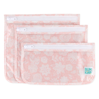 Bumkins Clear Travel Bag 3-Pack: Lace includes 3 TSA-compliant pouches made of pink waterproof fabric with a white lace design.