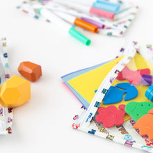 Load image into Gallery viewer, Close-up of Bumkins Clear Travel Bag 3 Pack: Mickey & Friends Varsity filled with colorful art supplies on a white background.