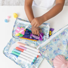 Load image into Gallery viewer, A child organizes colorful markers, glue, and pom-poms into Bumkins Clear Travel Bag 3 Pack: Aloha Stitch on a white table.