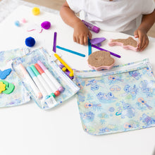 Load image into Gallery viewer, A child uses markers and crafts at a white table, surrounded by Bumkins Clear Travel Bag 3 Pack: Aloha Stitch.