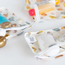 Load image into Gallery viewer, Close-up of Bumkins Clear Travel Bag 3-Pack: Winnie and Friends with TSA-compliant bottles on a white background.