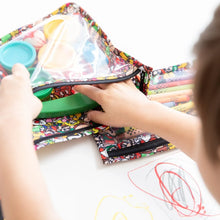 Load image into Gallery viewer, Close-up of a child sorting art supplies in Bumkins Clear Travel Bag 3-Pack: Super Mario™ Mashup, with crayons and drawings on the table.