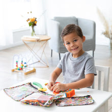 Load image into Gallery viewer, A child plays with colorful toys at a table with Bumkins Clear Travel Bag 3-Pack: Super Mario™ Mashup in a bright living room.