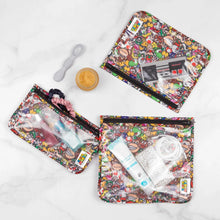 Load image into Gallery viewer, Bumkins Clear Travel Bag 3-Pack: Super Mario™ Mashup holds baby items and toiletries, with a spoon and food jar on a marble background.