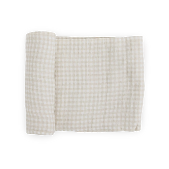Little Unicorn Cotton Swaddle in Tan Gingham, partially rolled, shown on a white background.