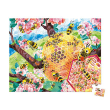 Load image into Gallery viewer, Janod Juratoys Bee Life 100 Piece Puzzle: Bees, a beehive in cherry blossoms, and lush green hills form a vibrant ecosystem.