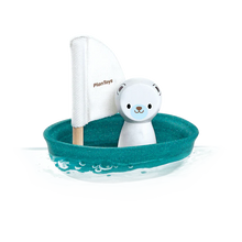 Load image into Gallery viewer, PlanToys Sailing Boat, Polar Bear: Sustainable toy sailboat with a teal base, white sail, and polar bear figure floats on water.