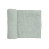 Little Unicorn Organic Cotton Muslin Swaddle in White Sage, OEKO-TEX certified, partially unrolled on a white background.