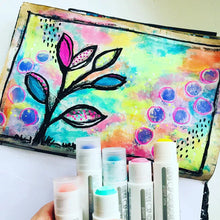 Load image into Gallery viewer, Hand holding vibrant Life of Colour Pastel Gouache Paint Stix; create abstract leaves and circles mess-free on a painted background.