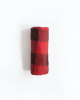 A folded Little Unicorn Red Plaid Cotton Swaddle on a plain white background.