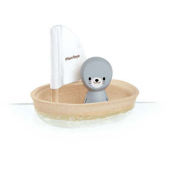 PlanToys Sailing Boat, Seal includes a gray seal in a wooden boat with a white sail. Sustainable fun on the water!.