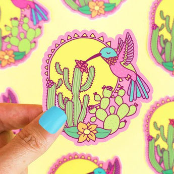 Turtle Soups Vinyl Sticker, Desert Hummingbird features a vibrant hummingbird and cactus against a sun, perfect for weatherproof decor.