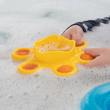 Load image into Gallery viewer, Hands engage with the Dimpl Splash by Fat Brain Toy Co in soapy water; its yellow design enhances fine motor skills through sensory play.