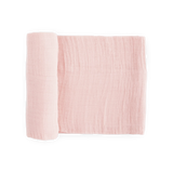 Little Unicorn Cotton Swaddle in light pink, partly rolled up on a white background.