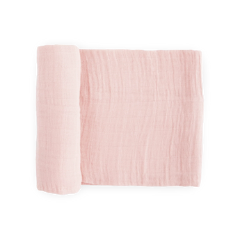 Little Unicorn Cotton Swaddle in light pink, partly rolled up on a white background.