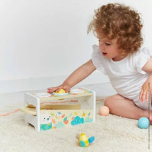 Load image into Gallery viewer, A child plays with a Janod Juratoys Wooden Xylophone on a carpet, surrounded by scattered balls, resembling a lively xylo session.
