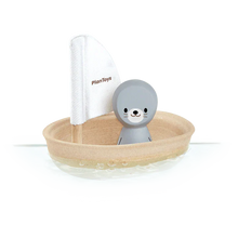 Load image into Gallery viewer, Discover the eco-friendly PlanToys Sailing Boat, Seal: a sustainable toy with PlanWood, featuring a gray seal figure and white sail.