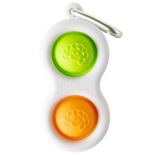 Load image into Gallery viewer, The Fat Brain Toy Co Simpl Dimpl is a white keychain with two silicone bubbles (green &amp; orange) for tactile fun, featuring a sturdy metal clip.
