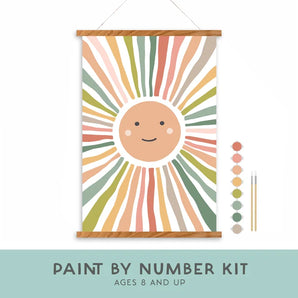 Kids Paint By Number Kit, Smiley Sunshine: sun hanging canvas, 2 brushes, & 8 acrylic paints. Text "Paint By Number Kit Ages 8 and Up."