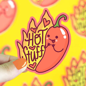 Turtle Soups Hot Stuff Vinyl Sticker held by orange-nailed hand on yellow background, featuring hearts and a chili pepper design.