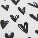 Close-up of water droplets on Bumkins Splat Mat: Hearts.