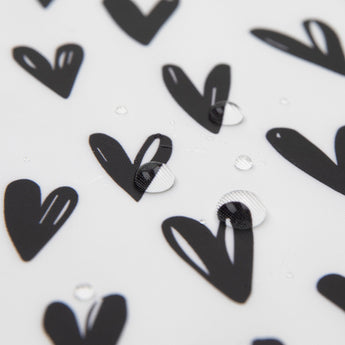 Close-up of water droplets on Bumkins Splat Mat: Hearts.