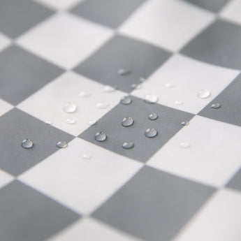Close-up of water droplets on Bumkins Wet/Dry Bag: Charcoal Check.
