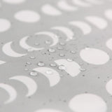 Close-up of water droplets on Bumkins Wet/Dry Clutch: Lunar Phase.