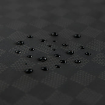 Close-up of water droplets on Roamio by Bumkins Wet/Dry Bag: Rich Black.