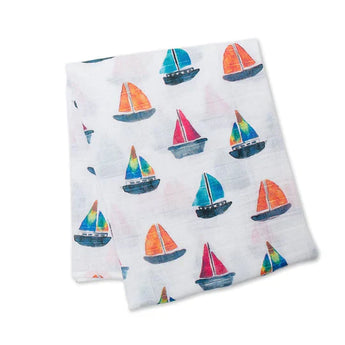 Lulujo Inc.s Cotton Swaddle, Sailboats: White fabric with red, blue, and green sailboat patterns ideal for swaddles or baby blankets.