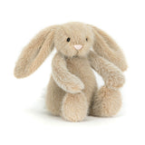 The Jellycat Flufflet Bunny Oat is a plush beige bunny with floppy ears sitting upright on a white background.