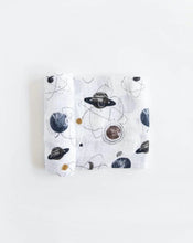 Load image into Gallery viewer, Lightweight cotton swaddle by Little Unicorn with space-themed prints of planets and stars. Folded neatly.
