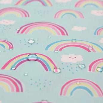 Close-up of water droplets on Bumkins Sleeved Bib: Rainbows.