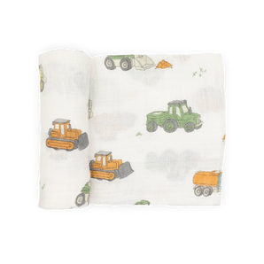 Little Unicorn Cotton Swaddle, Work Trucks: soft muslin blanket with green and orange trucks—breathable comfort for your baby.