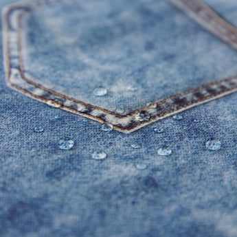 Close-up of water droplets on Roamio by Bumkins Wet Bag: Vintage Denim.