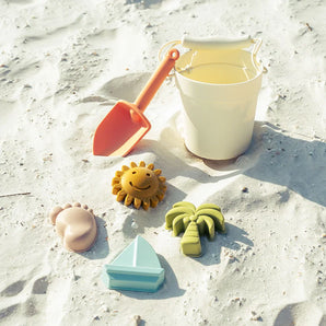 Emerson and Friends Beach Bucket Toy Play Set: Silicone bucket, orange shovel, sun, foot, palm tree & sailboat sea-themed toys.