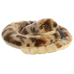 Aurora’s Ruse Rattlesnake is a cute, coiled plush with brown spots, yellow eyes, and a forked black tongue.