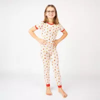 Load image into Gallery viewer, A smiling child poses in Emerson and Friends buttery soft Here For the Snacks bamboo PJs against a white background.
