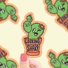 Load image into Gallery viewer, Turtle Soups Lookin Sharp vinyl sticker features a cute winking cactus in a pot, surrounded by blurry cactus illustrations.

