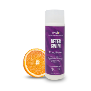 Vita C After Swim Conditioner, a chlorine neutralizer, is shown beside a sliced orange on a white background.