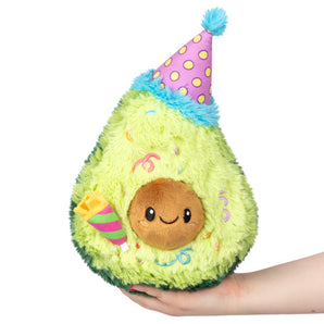 The Squishable Plush Birthday Avocado, made with polyester fiber, sports a party hat and smile—ideal for any age!.