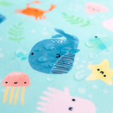 Close-up of water droplets on a Bumkins Reusable Snack Bag, Large 2-Pack: Ocean Life & Whale Tail.