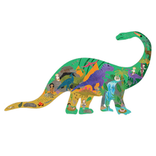 Load image into Gallery viewer, The Floss and Rock 80 Piece Puzzle: Dinosaur features a colorful jungle scene with animals and explorers for a fun adventure.
