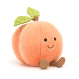 Jellycat Amuseables Peach plush has a smiling face, green leaf, and brown legs on a white background.
