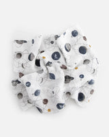 The Little Unicorn Cotton Swaddle, Planetary features a lightweight space-themed pattern with planets, rockets, and stars.